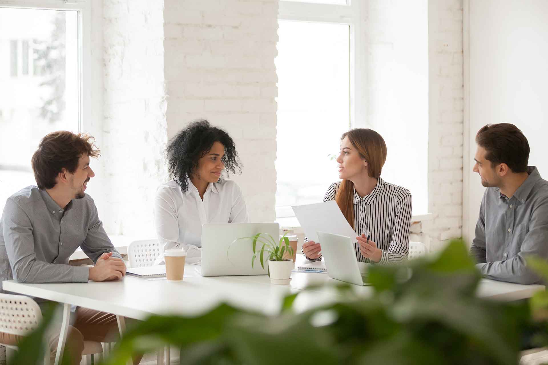 multiracial-male-female-colleagues-having-discussion-team-meeting